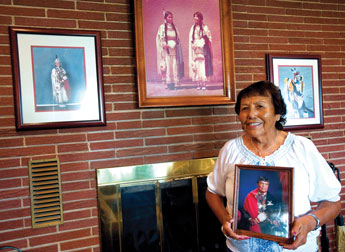 Surrounded by photos of her daughters, Virginia Jean Cometsevah holds a picture of her latehusband Arthur at her home in Gallup on Tuesday. Arthur Cometsevah was a Cheyenne chief ffrom Oklahoma who moved to New Mexico in 1965. Cometsevah's daughers will honor their father by dancing in this year's Inter-Tribal Indian Ceremonial. © 2011 Gallup Independent / Adron Gardner 